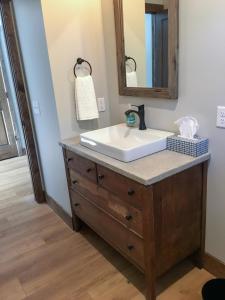 a bathroom with a sink and a mirror at Lakefront Home 4 Bedroom 4 Bath Sleeps 12 in Waupaca