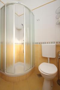 a bathroom with a shower and a toilet at Apartments by the sea Umag - 6095 in Umag