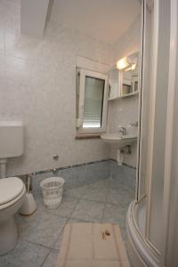 a bathroom with a toilet and a sink at Double Room Pag 6311b in Pag