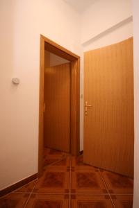 an empty room with a door and a wooden floor at Double Room Pag 6311b in Pag