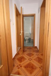 a hallway with a toilet in a bathroom at Apartment Pag 6311c in Pag