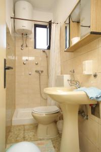 a bathroom with a sink and a toilet and a shower at Apartments by the sea Novigrad - 6979 in Novigrad Istria