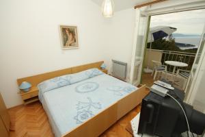 a bedroom with a bed and a balcony at Apartment Labin 7468b in Labin
