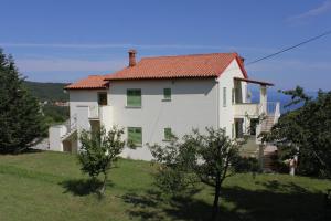 a white house with a red roof on a hill at Apartments with a parking space Labin - 7468 in Labin