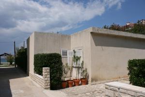 a building with plants on the side of it at Apartments by the sea Pag - 6413 in Pag