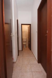 a hallway of a bathroom with a toilet and a door at Apartments by the sea Pag - 6413 in Pag