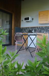a kitchen with a counter and a table and chairs at Lodges Mont-Vert in Le Robert