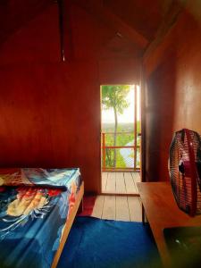 a small room with a bed and a window at Rumah Pohon in Nusa Penida