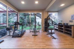 a gym with treadmills and ellipticals in a room at Hotel Laguetto Stilo Borges - Gramado - semana de 17 a 24 de janeiro de 2026 in Gramado