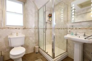 a bathroom with a shower and a toilet and a sink at Yoxford House, Ginger & Gold Ltd in Norwich