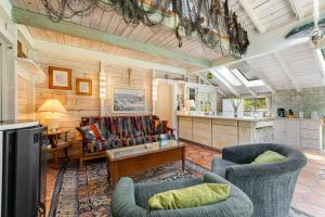 a living room with two chairs and a table at Mendocino Dunes - Dune Flower in Fort Bragg