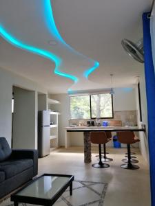 a kitchen with a blue light on the ceiling at Garza Tigre Apartamentos in Cóbano