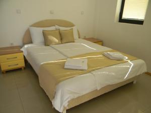 a large bed with two towels on top of it at Villa Kale in Ohrid