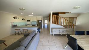 a living room with a couch and a kitchen at Unit 54 Seafront Estate in Jurien Bay