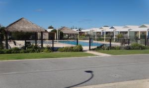 a street with a fence and some houses at Unit 54 Seafront Estate in Jurien Bay