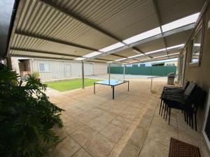 a covered patio with a table and chairs at Tre Sorelle in Jurien Bay