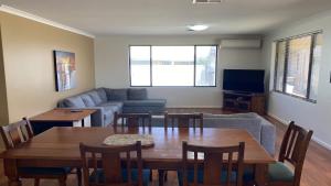 a living room with a table and a couch at Maniki Gardens in Jurien Bay