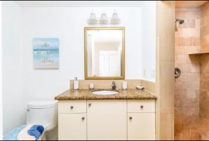 a bathroom with a sink and a mirror at La Vista Azul - Lovely Spacious Condo close to Grace Bay - Free Wi-Fi in Turtle Cove
