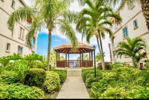 a gazebo in the middle of a building with palm trees at La Vista Azul - Lovely Spacious Condo close to Grace Bay - Free Wi-Fi in Turtle Cove