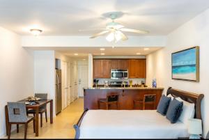 a living room with a bed and a kitchen at La Vista Azul - Lovely Spacious Condo close to Grace Bay - Free Wi-Fi in Turtle Cove