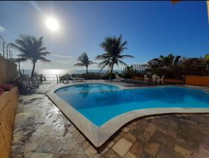 a swimming pool with a view of the ocean at Atlântico Flat - Apto 004 in Natal