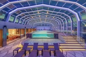 a swimming pool in a building with a ceiling at The Ambassador Seoul - A Pullman Hotel in Seoul