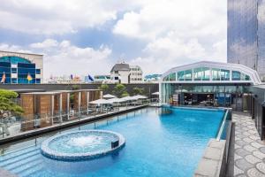 a large swimming pool on the roof of a building at The Ambassador Seoul - A Pullman Hotel in Seoul