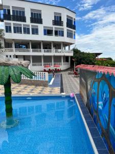a swimming pool in front of a building at Finca Don Matías in Melgar