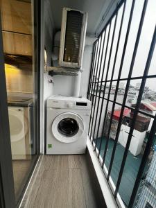 a washer and dryer in a room with a balcony at Era Apartment Đông Tác in Hanoi