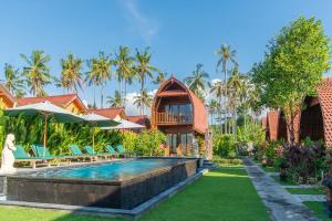a villa with a swimming pool and a resort at Kukuh Penida Village by Bukit Vista in Nusa Penida