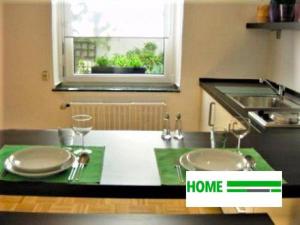 a kitchen with a counter with two sinks and a window at studio e - Quiet central business one bedroom apartment for 3 guests in Düsseldorf