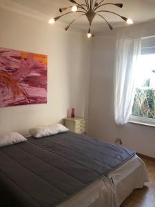 a bedroom with a large bed with a ceiling fan at studio e - Quiet central business one bedroom apartment for 3 guests in Düsseldorf