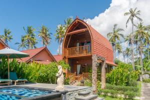 a villa with a pool and a house at Kukuh Penida Village by Bukit Vista in Nusa Penida