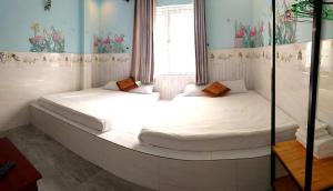 two beds in a room with a window at Ngan Giang Guesthouse in Phu Quoc