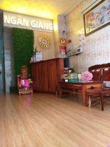 a room with a wooden floor and a nascan game sign at Ngan Giang Guesthouse in Phú Quốc