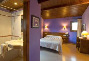A bed or beds in a room at Hotel Can Blanc