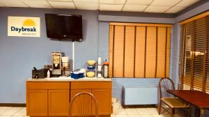 a dining room with a table and a tv on the wall at Days Inn by Wyndham Salina South in Salina
