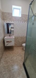a bathroom with a shower and a sink and a toilet at Châu Gia Villa Vũng Tàu - Có chỗ đậu xe hơi in Vung Tau