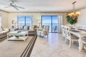a living room with a table and a dining room at Emerald Isle 602 in St. Pete Beach
