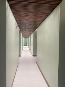 a corridor of an office building with a wooden ceiling at Mahayahay Lodge and Restaurant in Mactan