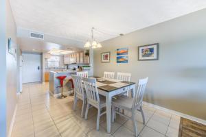 a kitchen and dining room with a table and chairs at Bayshore Yacht & Tennis 216 in Clearwater Beach