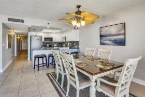 a dining room and kitchen with a table and chairs at Emerald Isle 103 in St Pete Beach