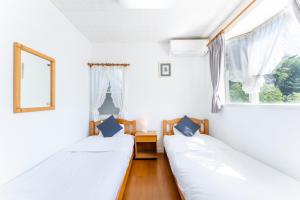 Postel nebo postele na pokoji v ubytování Tabist Kiyosato Grandeur Yatsugatake