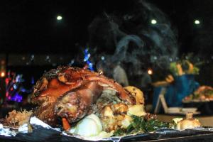 a piece of meat on a plate with smoke at Camellia Resort and Spa in Sigiriya