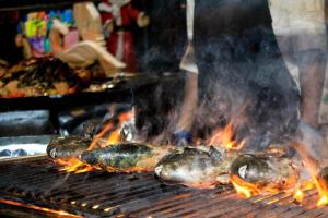 a group of food on a grill with flames at Camellia Resort and Spa in Sigiriya