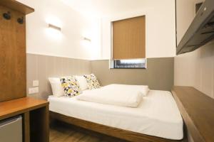 Ένα ή περισσότερα κρεβάτια σε δωμάτιο στο Lychee Sunset Hotel Cheung Chau