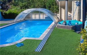 a swimming pool with a metal bridge over it at Amazing Home In Mandal With Kitchen in Mandal