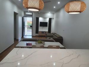 Executive Two Bedroom Villa For Hire in Nadi في نادي: غرفة معيشة مع طاولة وأريكة