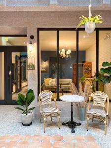 a patio with two chairs and a table and a couch at Minilove Homestay in Tainan