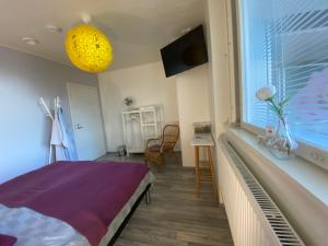 a bedroom with a bed and a window with a tv at Savonlinna Rentals in Savonlinna
